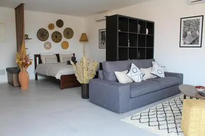 a living room with a couch and a bed at STUDIO MODERNE PROCHE MACDO RTE CASA in Marrakech