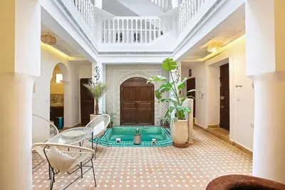 a living room with a pool in the middle of the room at Riad El Khir en centre ville rooftop et bassin in Marrakech