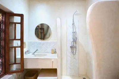 a bathroom with a sink and a mirror at Riad El Khir en centre ville rooftop et bassin in Marrakech