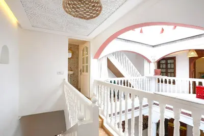a white staircase in a home with a ceiling at Riad El Khir en centre ville rooftop et bassin in Marrakech