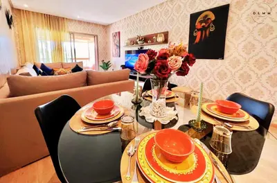 a living room with a table and a couch at Luxurious Stay at Prestigia Golf Marrakech with Golf Course, Pool, and Breathtaking Atlas Mountains View in Marrakech