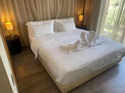 a bedroom with a bed with a white comforter at Appartement Privé 1 Chambre Vizir Center Marrakech in Marrakech