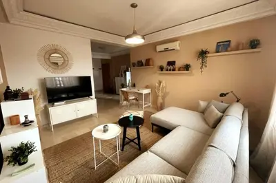 a living room with a couch and a table at Sunny terrace & comfy beds in Marrakech in Marrakech