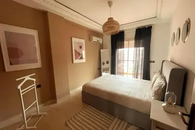 a bedroom with a bed and a desk and a window at Sunny terrace & comfy beds in Marrakech in Marrakech