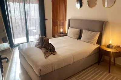 a bedroom with a large bed with white sheets at Sunny terrace & comfy beds in Marrakech in Marrakech