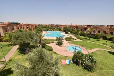 an overhead view of a courtyard with two swimming pools at Marrakech Atlas Golf Resort appartement 2 chambres,Piscines in Marrakech