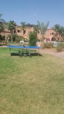 a picnic table in the grass in a park at Marrakech Atlas Golf Resort appartement 2 chambres,Piscines in Marrakech