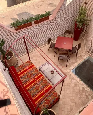 an overhead view of a patio with a table and chairs at Riad Dombaraka in Marrakech