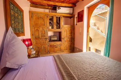 a bedroom with a bed and a large window at Riad Dombaraka in Marrakech