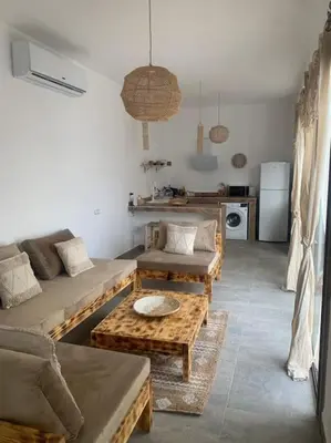 a living room with couches and tables and a kitchen at Magnifique villa sans vis-à-vis • Marrakech in Marrakech