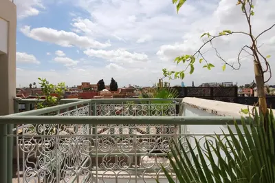 a balcony with a view of a city at RIAD CHOUKRI in Marrakech