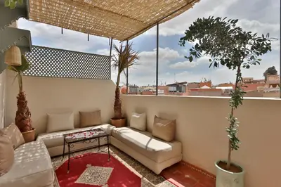 a living room with a couch on a balcony at RIAD CHOUKRI in Marrakech
