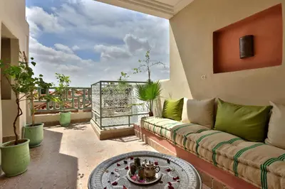 a living room with a couch and a table at RIAD CHOUKRI in Marrakech
