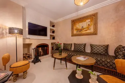a living room with a couch and a fireplace at Riad Celema & Spa in Marrakech