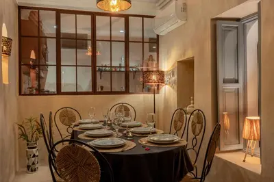a dining room with a table and chairs at Riad Celema & Spa in Marrakech