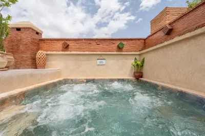 a pool of water in a brick wall at Riad Celema & Spa in Marrakech