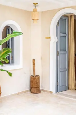 a room with a blue door and a wooden hammer at Riad Celema & Spa in Marrakech