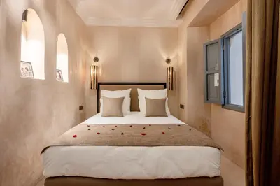 a bedroom with a large bed with red roses on it at Riad Celema & Spa in Marrakech