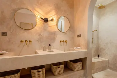 a bathroom with a sink and two mirrors and a tub at Riad Celema & Spa in Marrakech