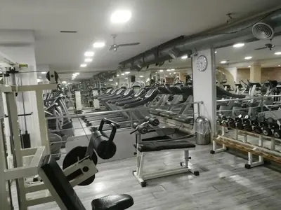 a gym with several rows of equipment in a room at Penthouse Marrakech in Marrakech