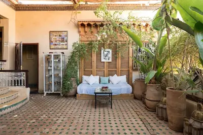 a bedroom with a bed in a room with plants at Penthouse Marrakech in Marrakech