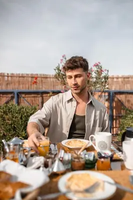 a man sitting at a table with food at Penthouse Marrakech in Marrakech