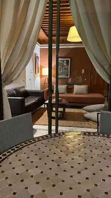 a living room with a couch and a table at Très joli Appart à la palmeraie coup de cœur in Marrakech