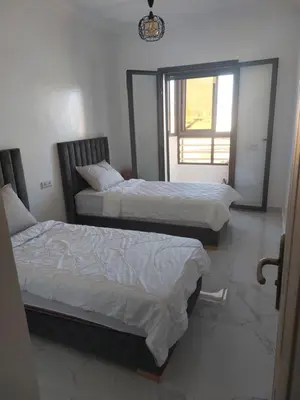 two beds in a room with a window at Marrakesh manara in Marrakech