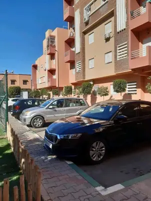 a black car parked in a parking lot next to a building at Marrakesh manara in Marrakech