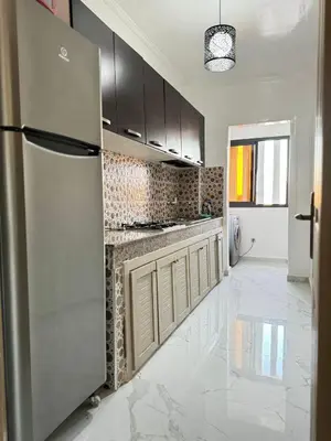 a kitchen with a stainless steel refrigerator and cabinets at Marrakesh manara in Marrakech