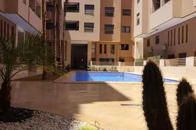 a swimming pool in the middle of a building at Menara Duplex in Marrakech