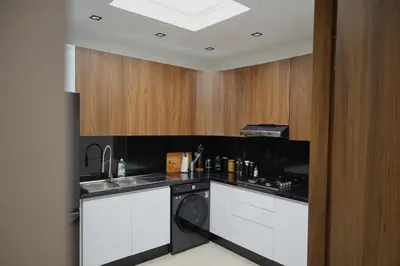 a kitchen with a sink and a dishwasher at Menara Duplex in Marrakech