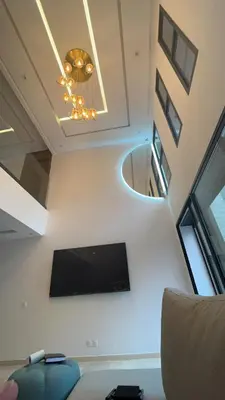 a living room with a tv and a ceiling at Menara Duplex in Marrakech