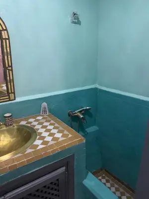 a bathroom with a sink and a mirror at RIAD ALGHANI in Marrakech