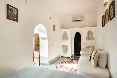 a living room with a white couch and an archway at RIAD ALGHANI in Marrakech