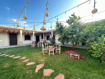 a garden with chairs and tables in the yard at Oasis Merasi Marrakech in Marrakech