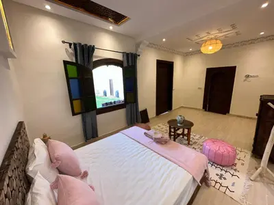 a bedroom with a large bed and a window at Oasis Merasi Marrakech in Marrakech