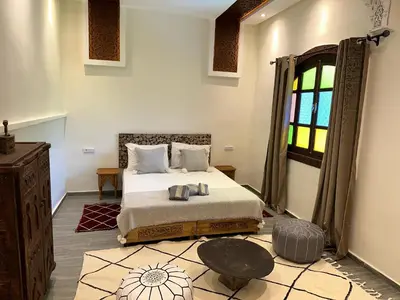 a bedroom with a bed and a window at Oasis Merasi Marrakech in Marrakech