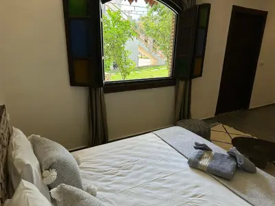 a bed in a room with a window at Oasis Merasi Marrakech in Marrakech