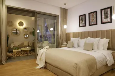a bedroom with a large bed and a bathroom at S_house in Marrakech