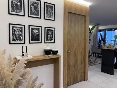 a room with a table with pictures on the wall at S_house in Marrakech