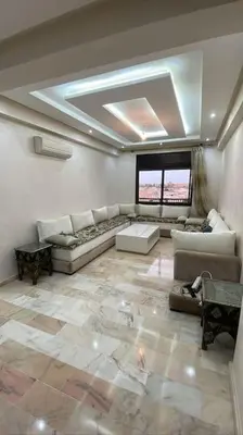 a large living room with couches and tables in it at Appartement Bellevue in Marrakech