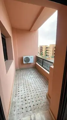 a balcony with a room with a microwave on it at Appartement Bellevue in Marrakech