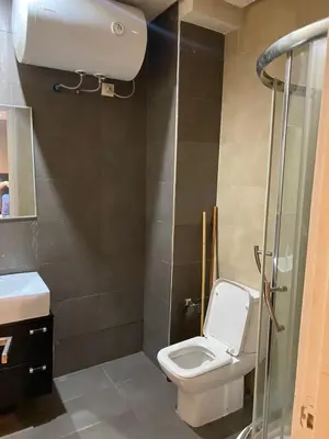 a small bathroom with a toilet and a shower at stylish appartment heart of gueliz in Marrakech