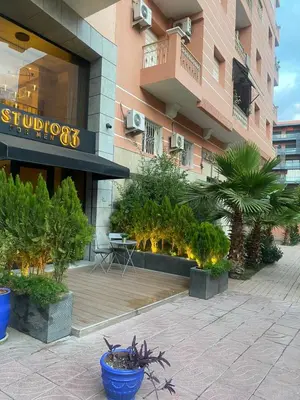 a building with a bunch of plants in front of it at stylish appartment heart of gueliz in Marrakech