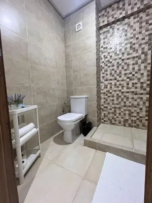 a bathroom with a white toilet and a sink at NOUR appartement in Marrakech