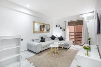 a white living room with a couch and a table at NEW! Chic Plein Gueliz, parking, Iptv in Marrakech