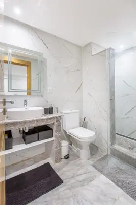 a white bathroom with a sink and a toilet at NEW! Chic Plein Gueliz, parking, Iptv in Marrakech