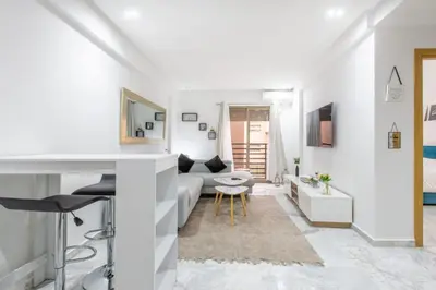 a white living room with a couch and a table at NEW! Chic Plein Gueliz, parking, Iptv in Marrakech