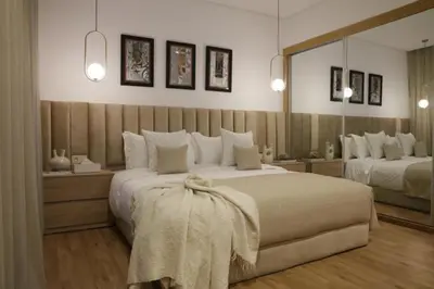 a bedroom with two beds and a large mirror at S_house in Marrakech